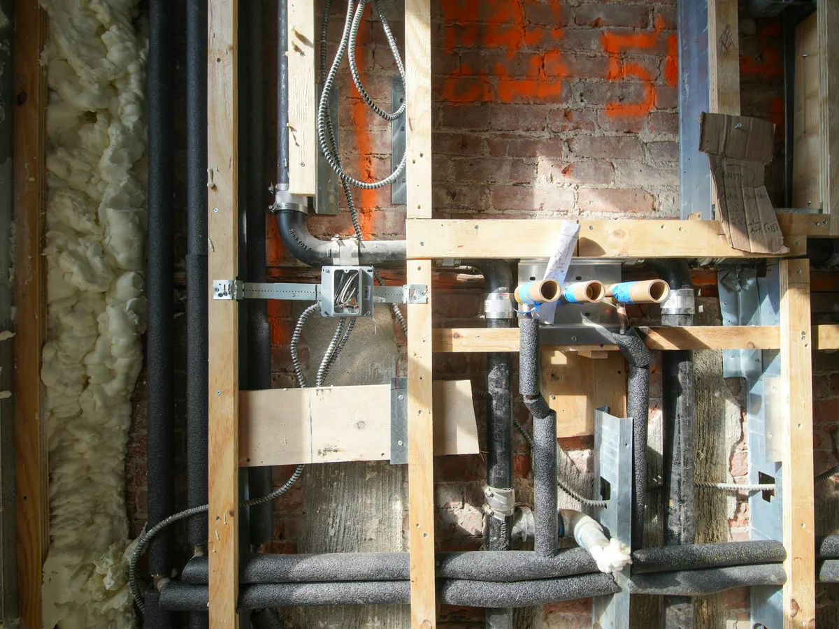 Plumbing and electrical rough-in inside wood stud walls